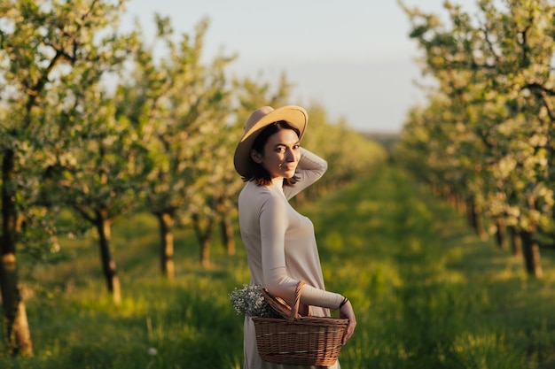 woman walking in the blooming spring orchard