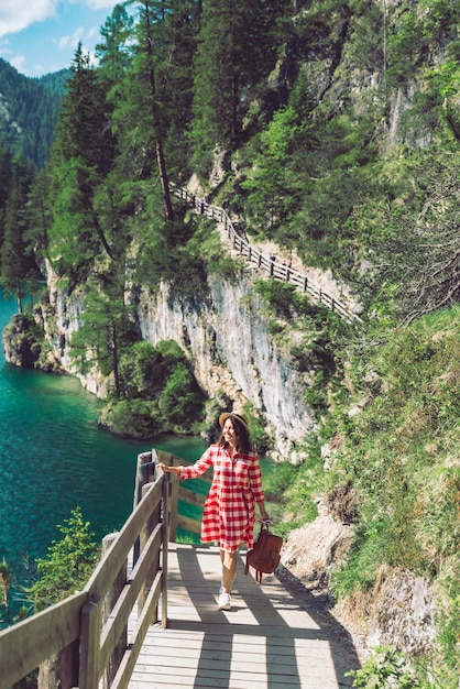 Woman walking by hiking trail around braies lake in italy dolomites mountains activity leisure lifestyle