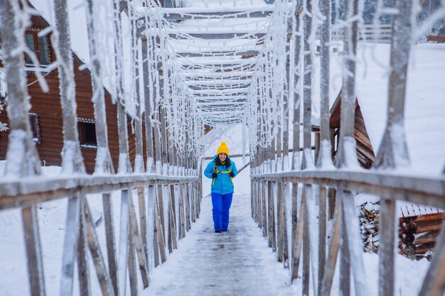 Woman walking by icy snowed stairs at winter mountains resort mountains resort