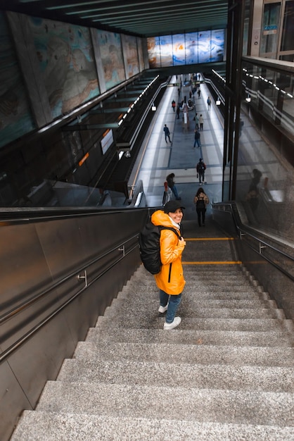 Woman walking by stairs down to metro subway underground station