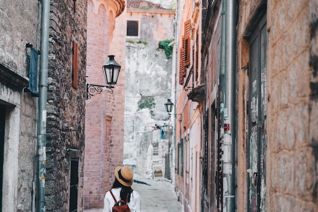 Woman walking by tight streets of kotor