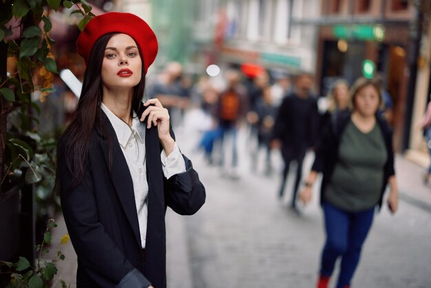 Woman walking down an old city street in a crowd sociophobia fear of crowds fear of people panic attack