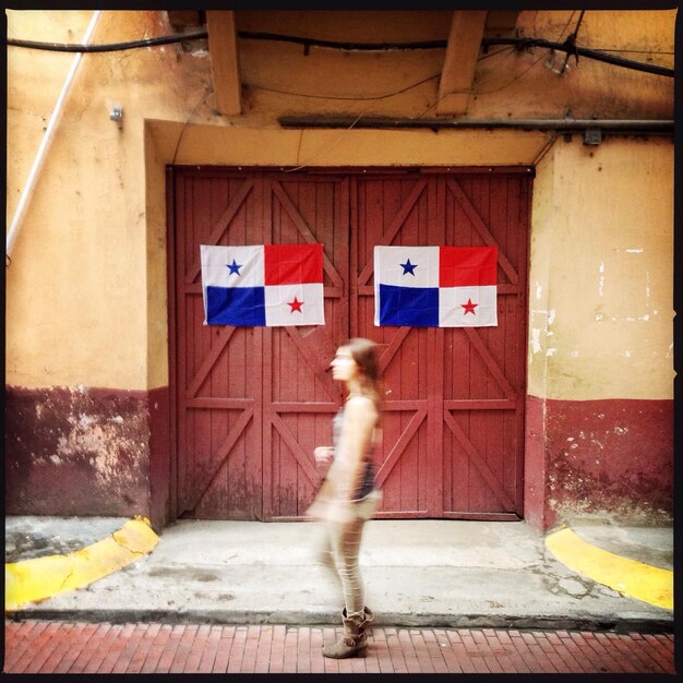 Woman walking next to gate