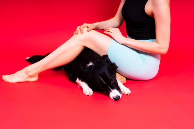 Woman walking and getting exercise for both herself and her border collie dog