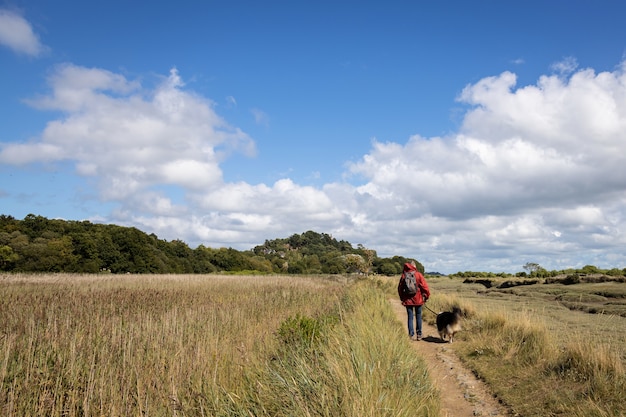 Woman walking her dog on a field