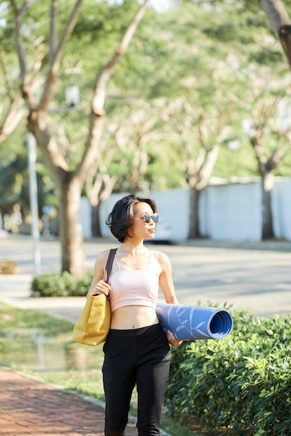 写真 ヨガマットの中を歩く女性