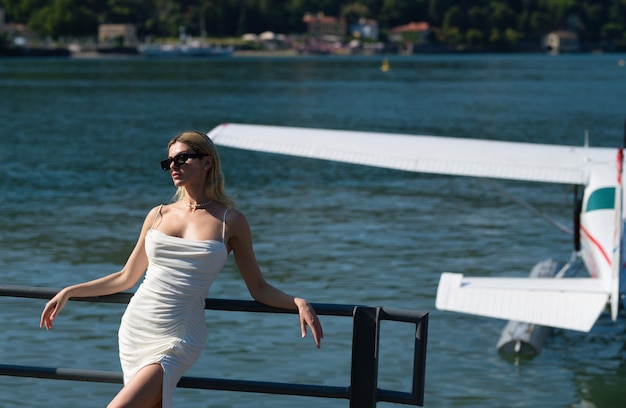 Woman walking on lake como italy girl in a sexy dress near lake como italian summer vacation fashion