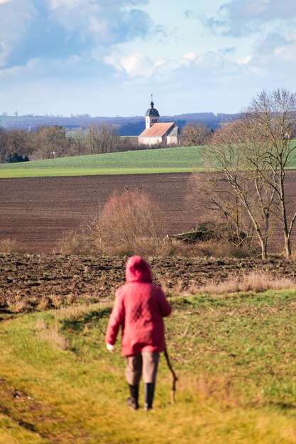 Woman walking on a path outdoors hiking pratice for relaxing and staying healthy