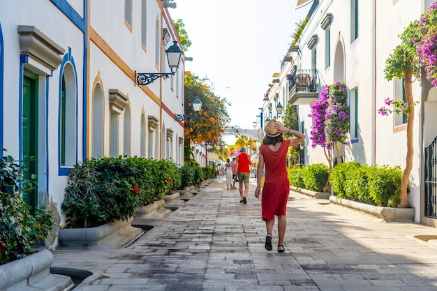 A woman walking in the port of the coastal town Mogan in the south of Gran Canaria Spain