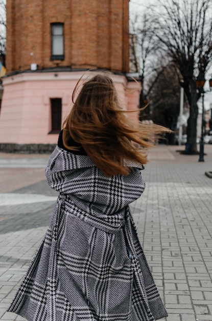 Woman walking on the street in a coat