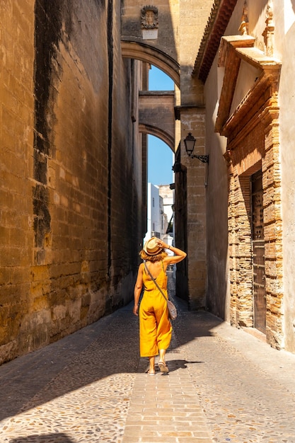A woman walking through the historic center of Arcos de la Frontera in Cadiz Andalusia