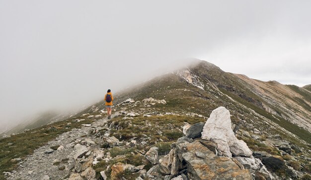 Woman walking on top of a mountain. Nuria valley. Hell's Peak