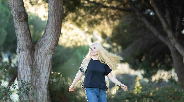 Woman walking among trees in the park