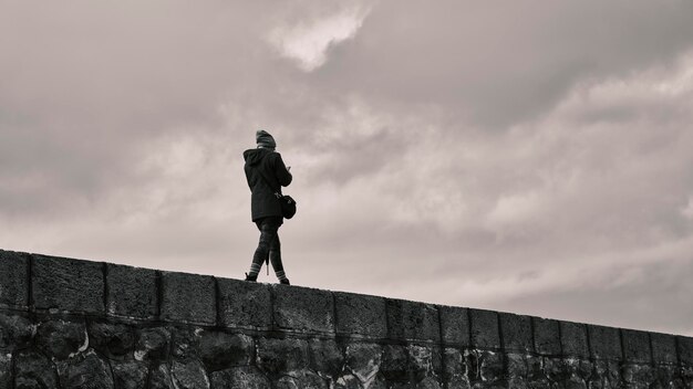 A woman walking on a wall