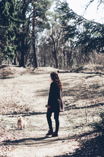 Woman walking with corgi