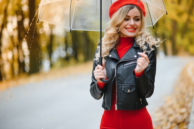 Woman walking with umbrella under the rain