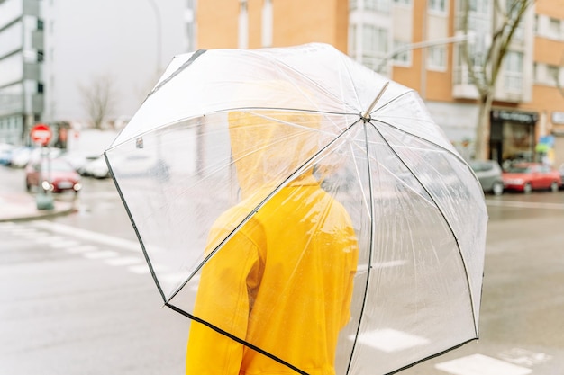 Woman walking with umbrella at street