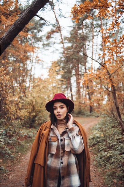 Woman walks in the autumn forest