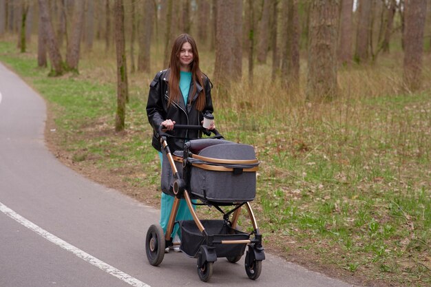 Photo a woman walks down a road with a stroller