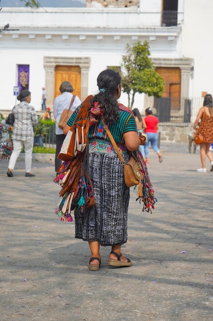 A woman walks in a plaza in guatemala.