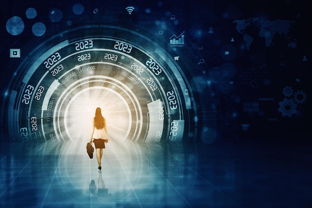 Woman walks toward futuristic tunnel background with 2023 text and interface graphic