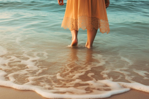 a woman walks in the water in a yellow dress