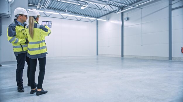 A woman in a warehouse with a sign on the wall