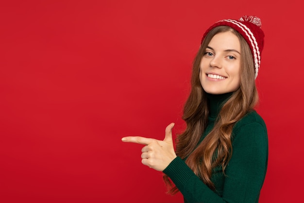 Woman in warm clothes pointing with finger