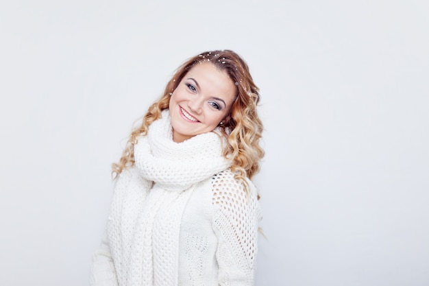 Woman in warm knitted scarf and gloves