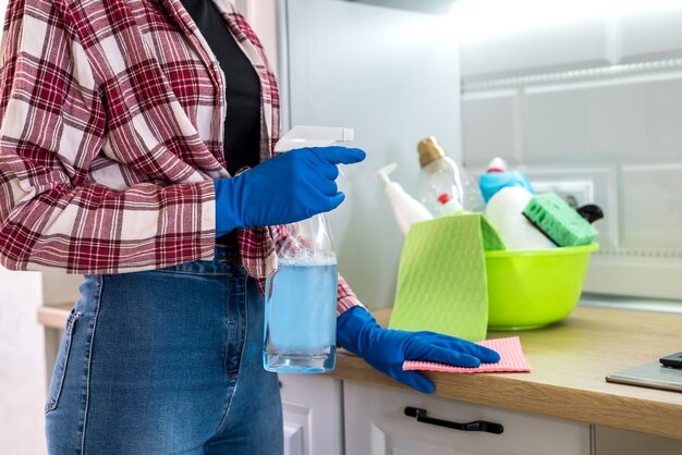 Woman washes and cleans in the kitchen.