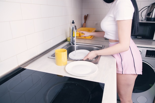 Woman washes the dishes