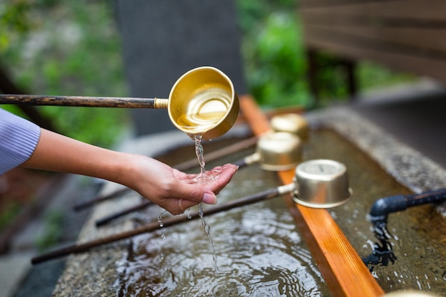 Woman washing hand in water fountain