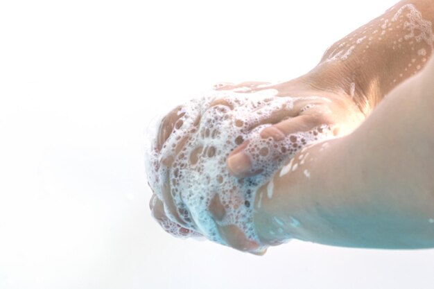 Photo woman washing hands against white background