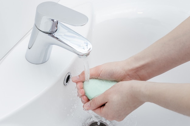 Woman washing hands with antibacterial soap for corona virus prevention, hygiene to stop spreading coronavirus.