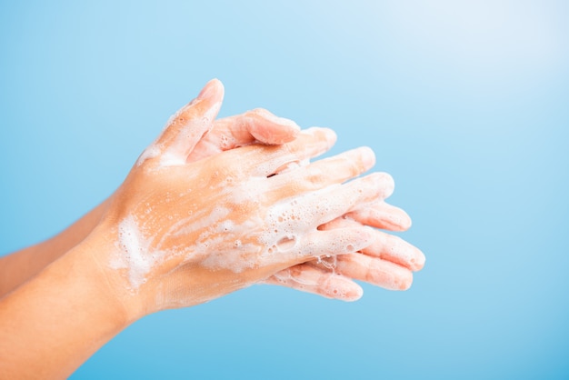 Woman washing hands with soap