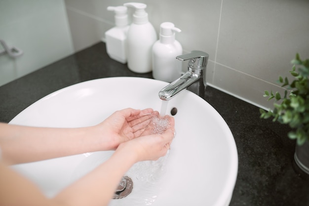 Woman washing her hands in the sink