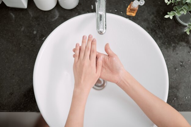 Woman washing her hands in the sink