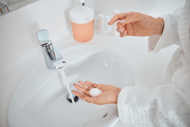 Woman washing her hands in the sink