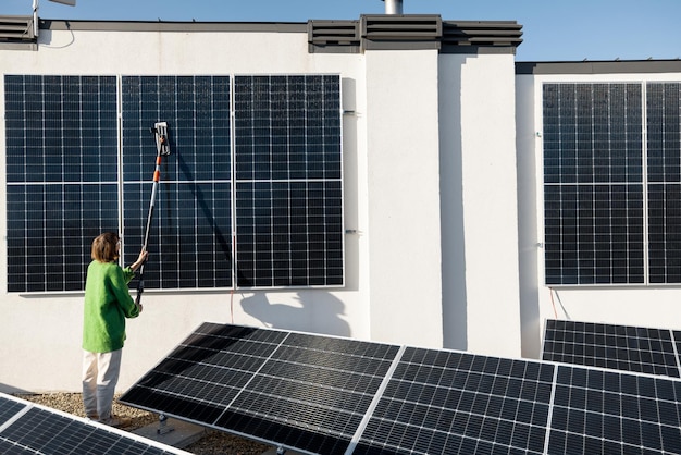 Woman washing solar panels on rooftop