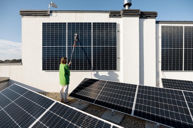 Woman washing solar panels on rooftop