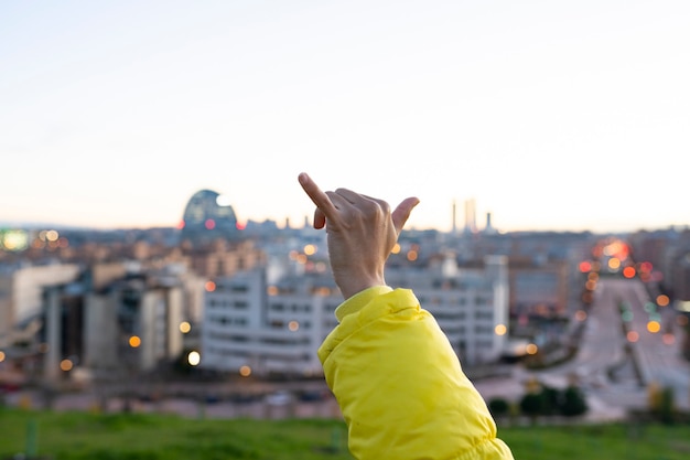 Woman watching the city from the top of a hill