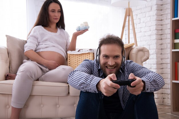 Woman Watching Shoes and Man Playing on Joystick