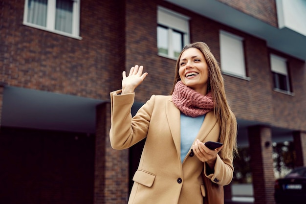 A woman wave on the street greeting concept