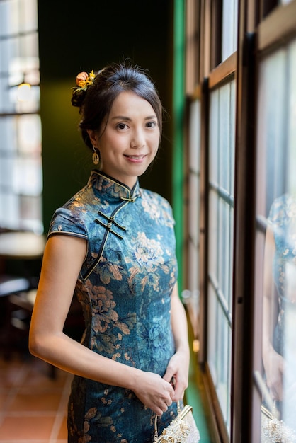 Woman wear traditional cheongsam in the restaurant