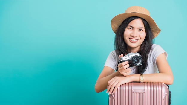 Woman wear white tshirt her holding suitcase bag and photo mirrorless camera