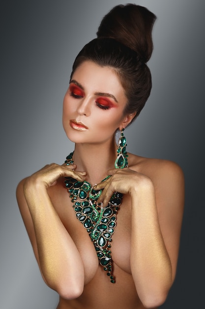  woman wearing big beautiful necklace with a lot of gems