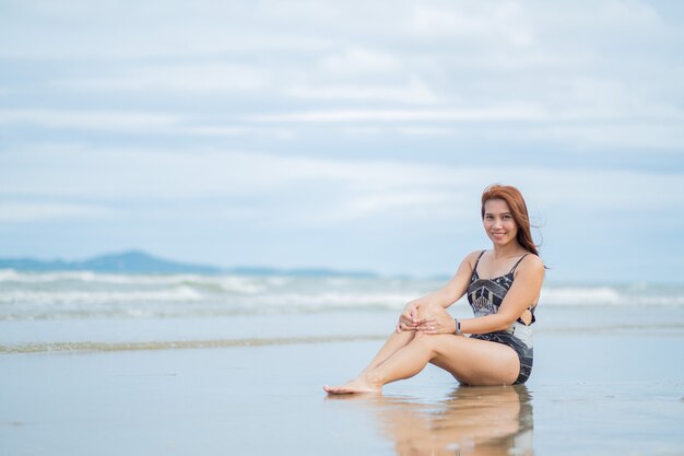 Woman wearing a bikini near sea shore