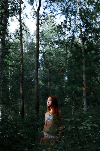 Photo woman wearing bikini while standing in forest