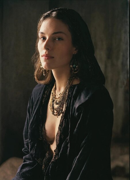 a woman wearing a black dress with a gold necklace