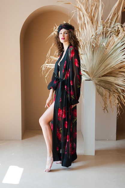 Woman wearing a black kimono with red flowers